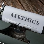 Máquina de escrever antiga com as palavras "AI Ethics" datilografadas em uma folha de papel.